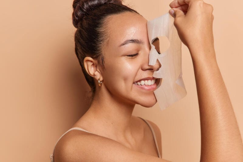 radiant young woman removes her sheet mask reveali 2024 01 03 00 07 16 utc